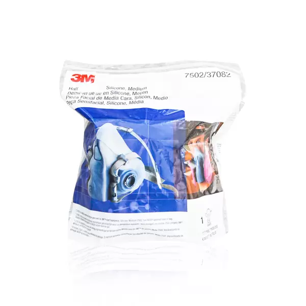 Un paquete de plástico sellado de un respirador de media máscara de silicona de tamaño mediano, marca 3m. el paquete incluye imágenes y descripciones del producto en varios idiomas, con un número de modelo visible 7502/37082.